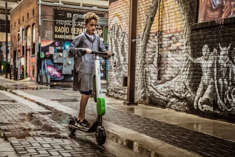 a boy riding a scooter